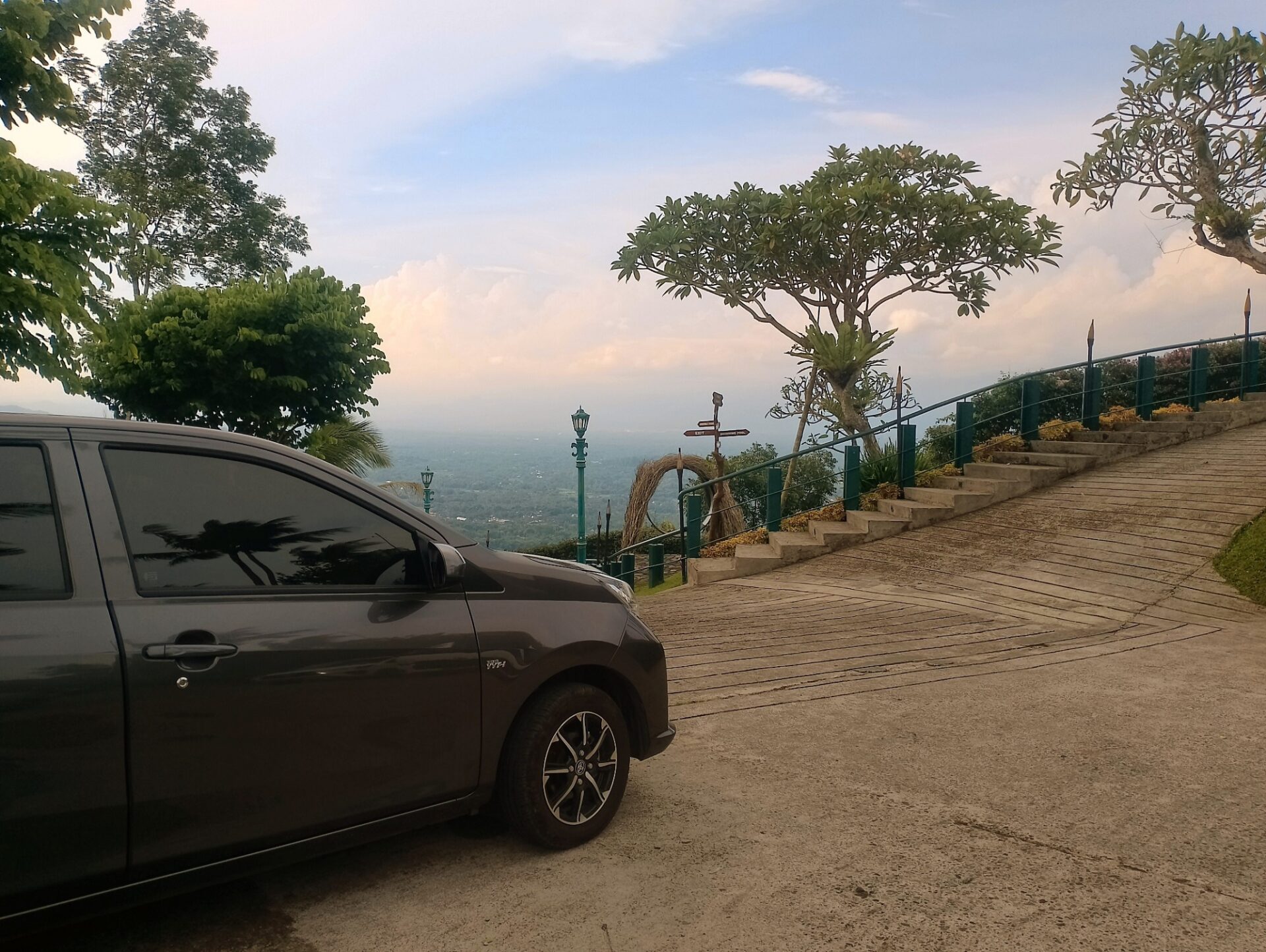 Comfortable and clean private tourist car of Private Driver Yogyakarta parked at Kaki Langit restaurant, ready for the safe journey from Yogyakarta to Jepara.
